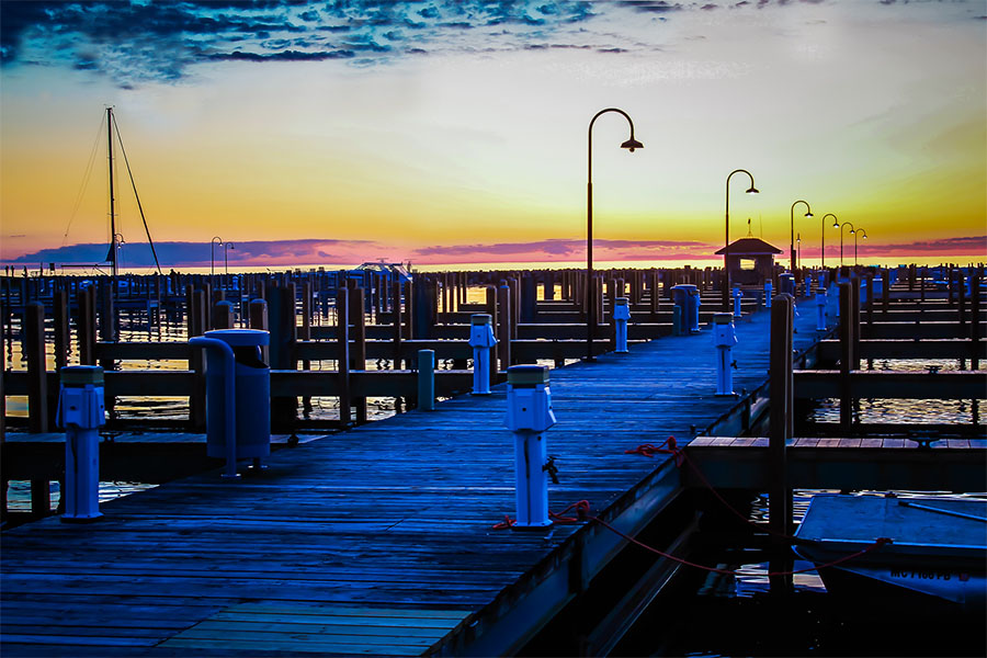 Client Center - Scenic View of a Marina on the Harbor in Petoskey Michigan with a Colorful Sunset Sky