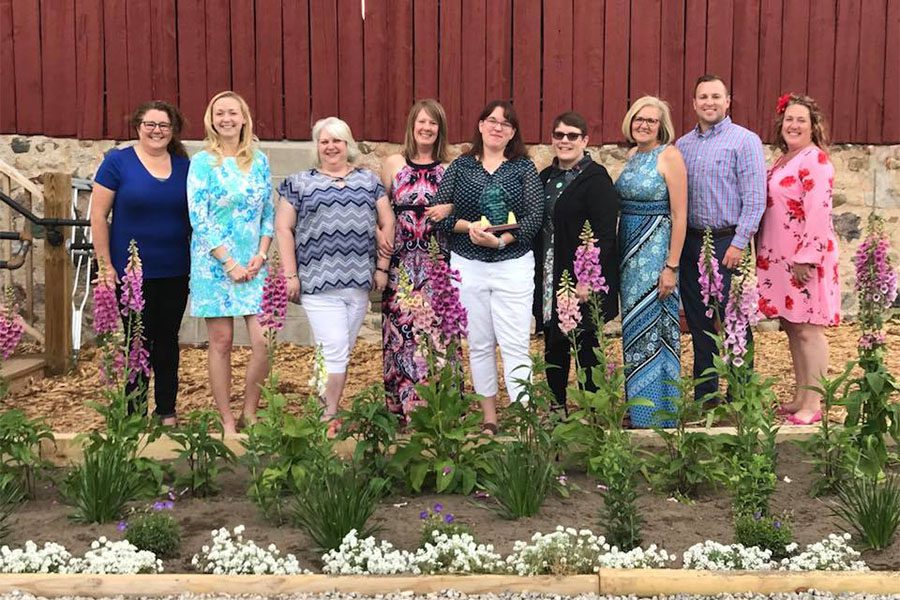 Our Culture - Portrait of the Harbor Brenn Insurance Staff Receiving an Award