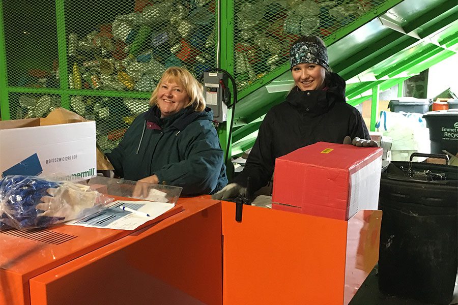 Our Culture - Two Smiling Harbor Brenn Insurance Employees at Recycling Facility